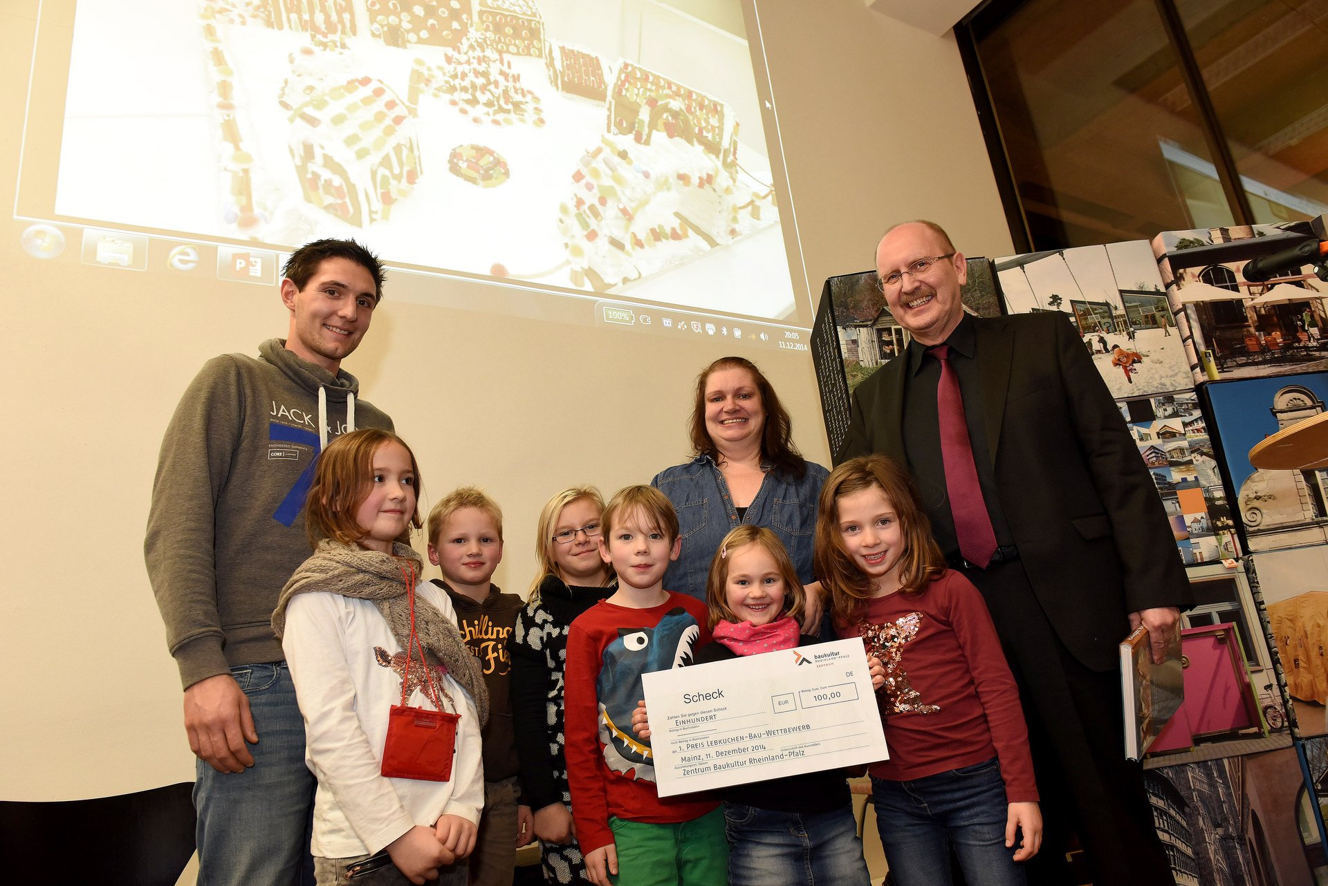 Mehrere Kinder sowie drei erwachsene lächeln in die kamera. Ein kleines Mädchen hält stolz einen übergroßen Scheck in den Händen. Mehrere Kinder sowie drei erwachsene lächeln in die kamera. Ein kleines Mädchen hält stolz einen übergroßen Scheck in den Händen.